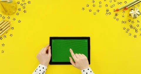 View from above on the black tablet device on the yellow table with birthday Stock Footage 89325936