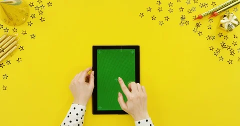 View from above on the black tablet device on the yellow table with birthday Stock Footage 89326242