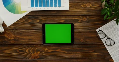View from above on the black tablet device with a green screen being Video stock 89987360