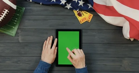 View from above on the black tablet device lying vertically on the dark grey Video stock 96340969