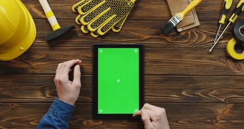 View from above on the black vertical tablet computer on the wooden desk of Video stock 96183728