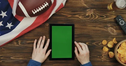View from above on the black vertical tablet device in hands of a man on the Stock-Footage 96322805