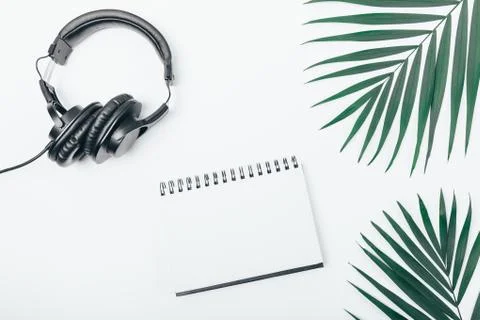 View from above blank notepad near black headphones Stock Photos