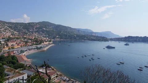 View from above of a blue bay dotted with anchored boats framed by green hills, Stock Footage 344813818