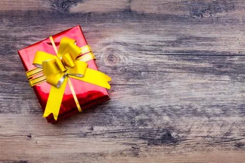 View above brown gift box and red ribbon with tag on wood background with spa Stock Photos