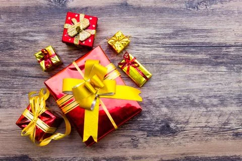 View above brown gift box and red ribbon with tag on wood background with spa Stock Photos