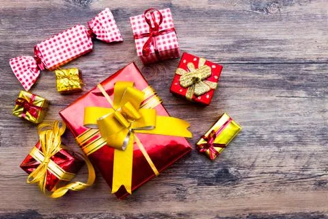 View above brown gift box and red ribbon with tag on wood background with spa Stock Photos