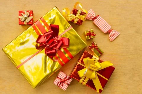 View above brown gift box and red ribbon with tag on wood background with spa Stock Photos