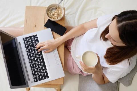 View from above of brown haired unrecognizable woman in t-shirt sitting on .. Stock Photos