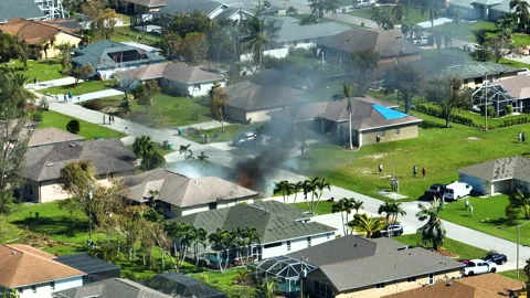 View from above of burning private house on fire and firefighters extinguishing Video stock 244643207