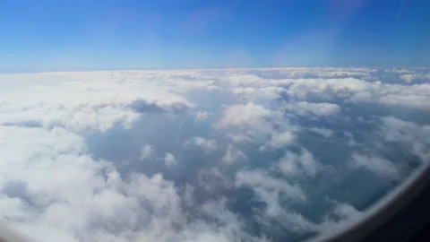 View above the clouds from an airplane window Stock Footage 297520759