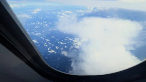 View above the clouds from an airplane window Stock Footage 297520883