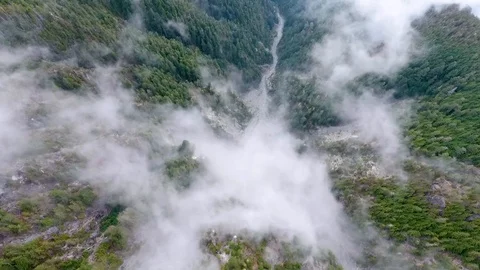 View from above clouds clinging to mountain side with forest Vídeo Stock 90680133
