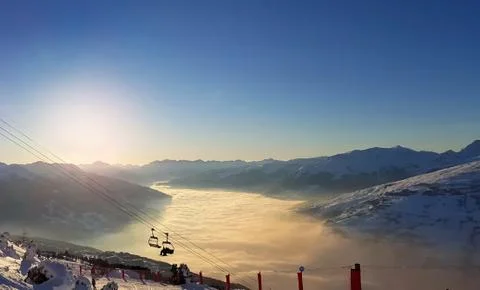 View above clouds in a valley at sunset Stock Photos