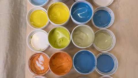 View from above of colorful jars with glazes and engobes Stock Footage 306278264