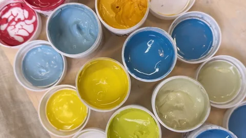 View from above of colorful jars with glazes and engobes Vídeo Stock 306278278