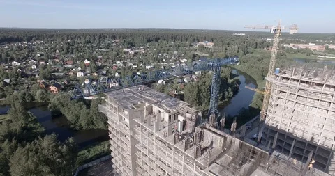 View above construction of houses with two cranes and few workers on the roof Stock Footage 105080260