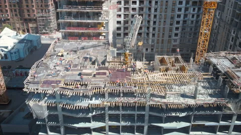 View from above to the construction works on the rooftop of a skyscraper. Stock Footage 181423758