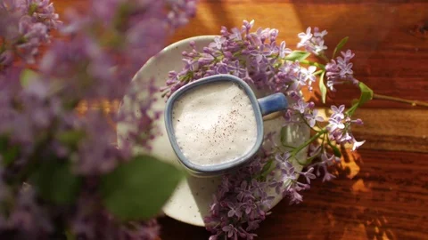 View from above, cup of fresh coffee and a bouquet of lilac Stock Footage 91156800