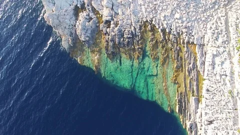 View from above of dangerous Dalmatian cliffs immersed in crystal clear sea Stock Footage 72802798