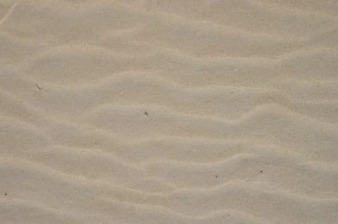 View from above, diagonal wave direction. Wind marks on the beach sand. Stock Photos