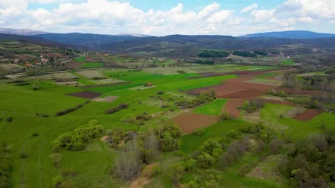 View from above, drone video over green fields and meadows in Sokobanja Stock Footage 241285152