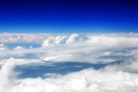 View above the earth at the clouds below. Stock Photos