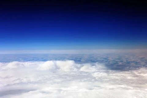 View above the earth at the clouds below. Stock Photos