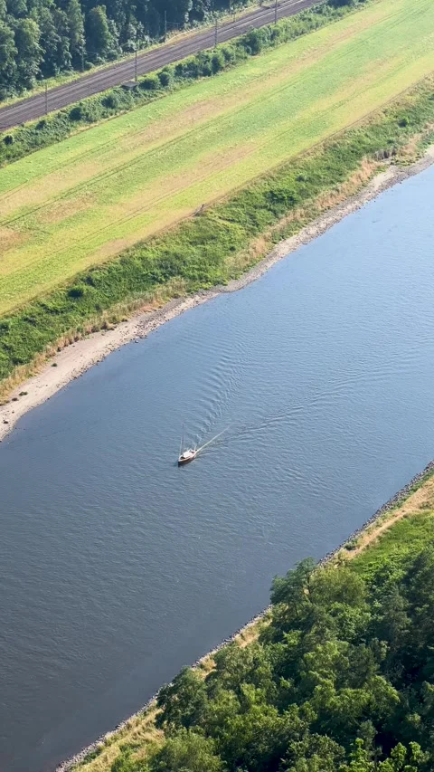 View from above of the Elbe River with a canoe against a background of greenery Stock Footage 303894546
