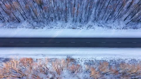 View from above of an empty track running through the edge of the snow-covered Stock Footage 165382725
