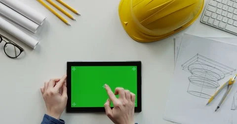 View from above on the female constructor's hands scrolling and tapping on the Stock Footage 96193301