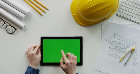 View from above on the female constructor's hands scrolling and tapping on the Stock-Footage 96193416