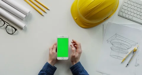 View from above on the female constructor's hands scrolling and tapping on the Stock-Footage 96194708