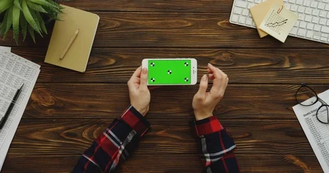 View from above on the female hands with the red plaid sleeves using the white Video stock 88419682