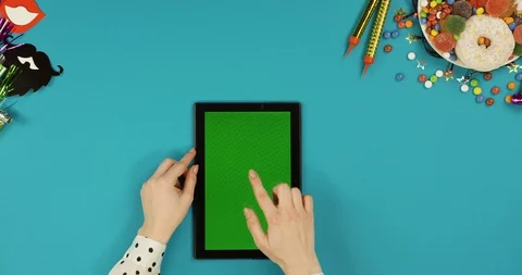 View from above on the female hands scrolling, taping and zooming on the green Stock Footage 89308944