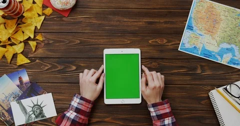 View from above on the female hands scrolling and taping on the white tablet Stock Footage 91716618