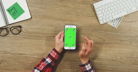 View from above on the female hands using the white vertical smartphone with a Stock Footage 89957745
