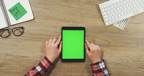 View from above on the female hands using the black vertical tablet device with Stock Footage 89958678