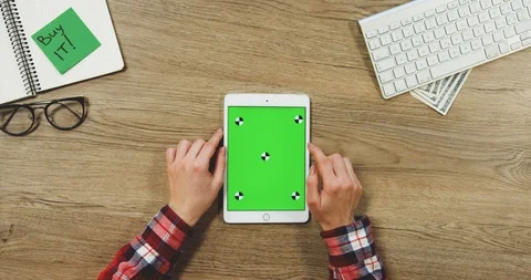 View from above on the female hands using the white vertical tablet device with Stock Footage 89959310