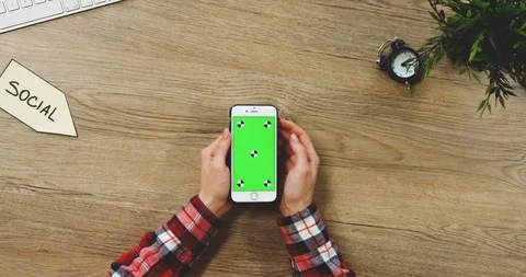 View from above on the female hands using the white vertical smartphone with a Stock Footage 89961251