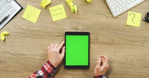 View from above on the female hands using the black vertical tablet device with Stock Footage 89964382