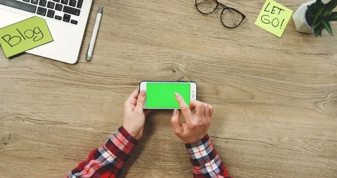 View from above on the female hands using the white horizontal smart phone with Stock Footage 89969834