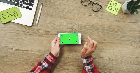 View from above on the female hands using the white horizontal smart phone with Stock-Footage 89970017