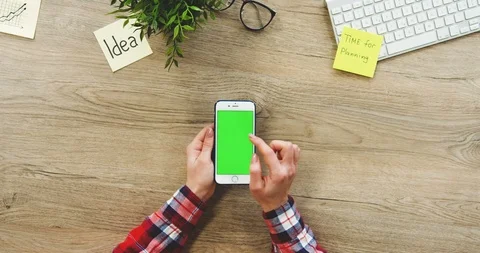 View from above on the female hands using the white vertical smartphone with a 스톡 동영상 89974930