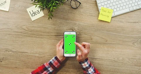 View from above on the female hands using the white vertical smartphone with a Stock Footage 89975237