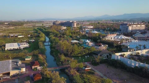 A view from above, the flight of the drone along the river above the trees and Video stock 93805553