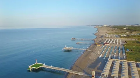 A view from above, flying a drone along the beach with sun loungers. Stock-Footage 93300397