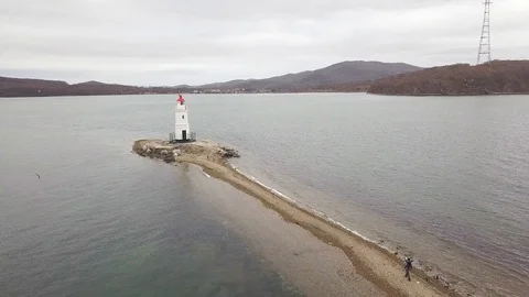 View from above flying drone lighthouse on sea shore. Aerial view sea beacon Stock Footage 92539077