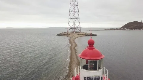 View from above flying drone lighthouse and communication tower on sea coast Stock Footage 93394654