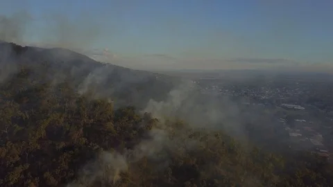 View above forest fire next to city Stockbeeldmateriaal 89737131
